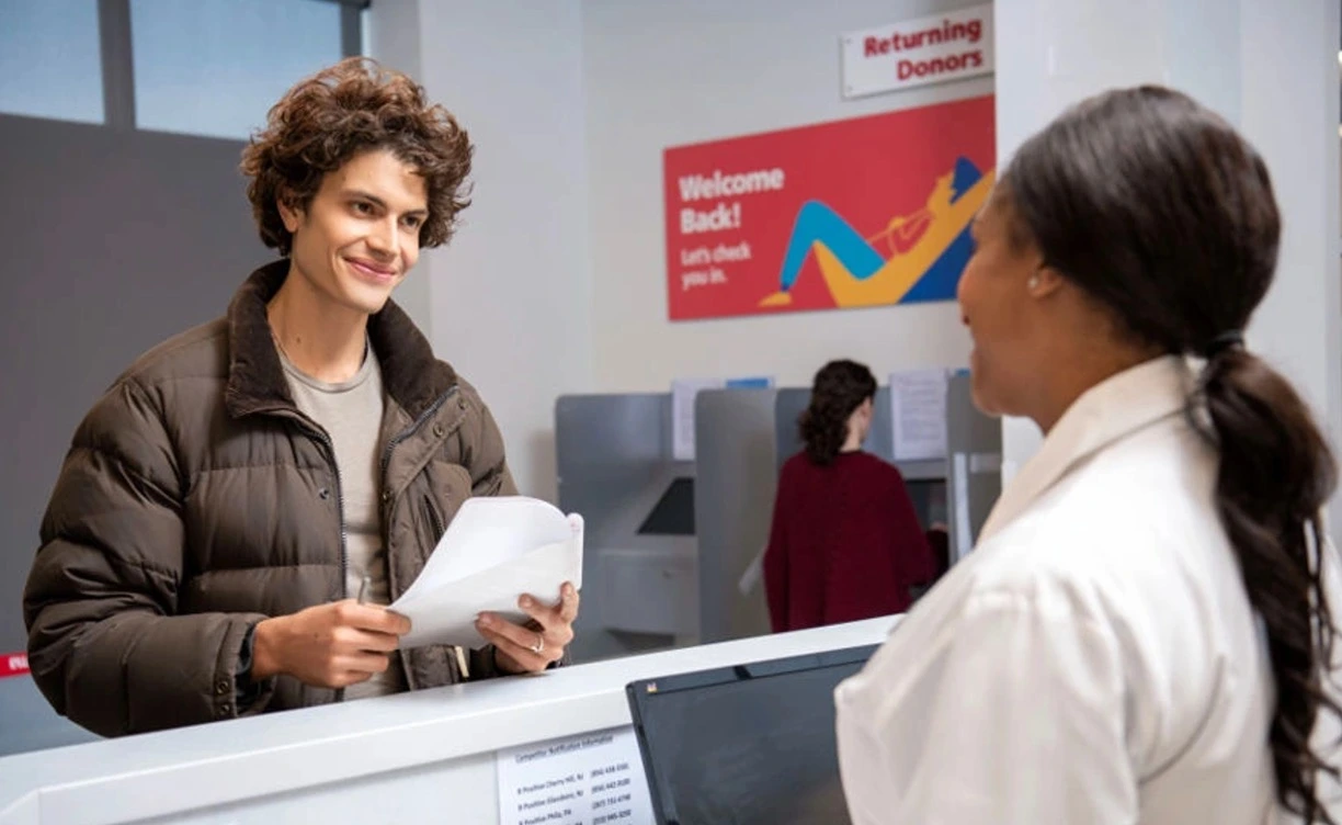 Plasma donor filling out paperwork